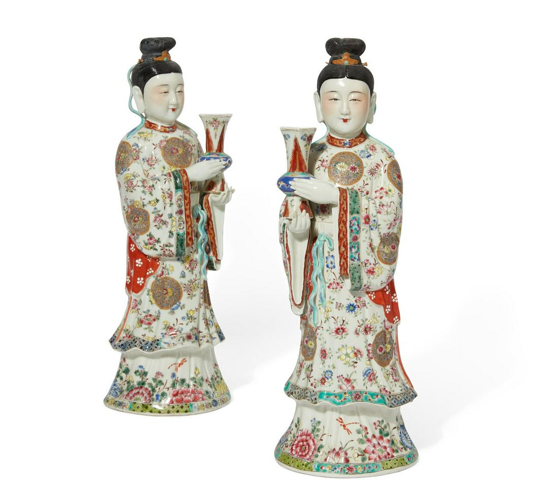 A pair of Chinese Famille Rose models of ladies: A pair of Chinese Famille Rose porcelain models of ladies holding gu vases height 15 3/4in (40cm); width 5 1/2in (14cm); depth 4 1/2in (11.5cm)
