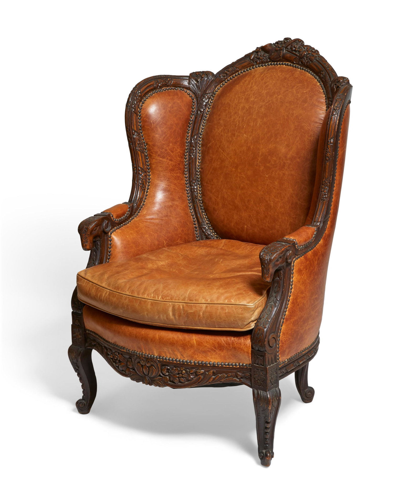 A Louis XV style leather upholstered armchair: A Louis XV style carved wood leather upholstered armchair height 46in (117cm); width 31 1/2in (80cm); seat depth 24 (61cm) Provenance: Property from a Private Collection, Long Beach, California.