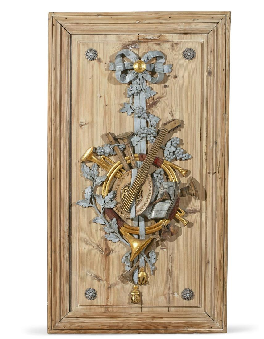 A Louis XVI musical trophy boiserie panel: A Louis XVI parcel gilt, silvered and red painted pine musical trophy boiserie panel late 18th century height 48 1/2in (123cm); width 27in (68.5cm)