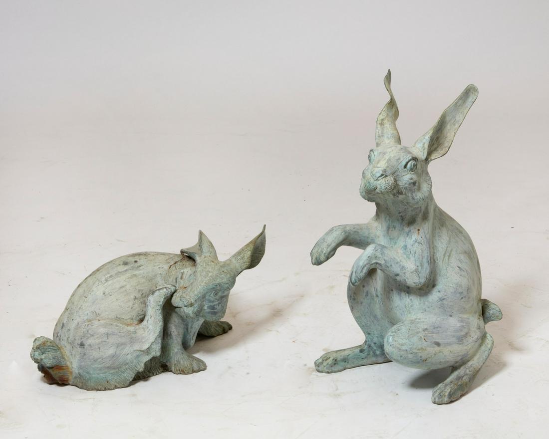 A pair of verdigris metal models of rabbits (1 of 4)