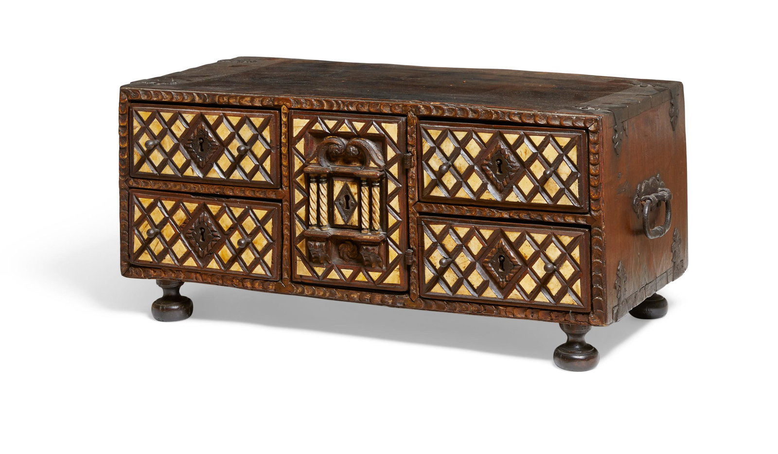 A Spanish Baroque chestnut table cabinet: A Spanish Baroque bone inlaid steel mounted chestnut table cabinet 17th century The central door enclosing a pair of drawers. height 12in (30.5cm); width 26 1/2in (67.5cm); depth 13 1/2in (34.5cm) Pro