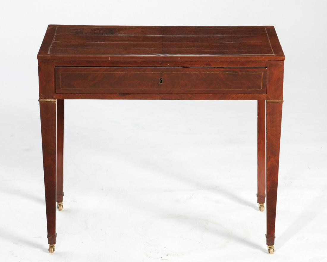 A Directoire brass inlaid mahogany writing table: A Directoire brass inlaid mahogany writing tablecirca 1800Fitted with a single frieze drawer and a writing slide to either side.height 28 3/4in (73cm); width 33 3/4in (86cm); depth 19 1/2in (49.5cm)