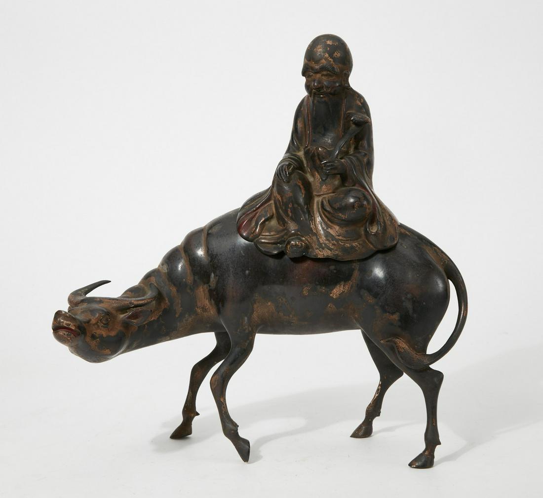 A Chinese bronze model of Lohan seated on an ox (1 of 3)
