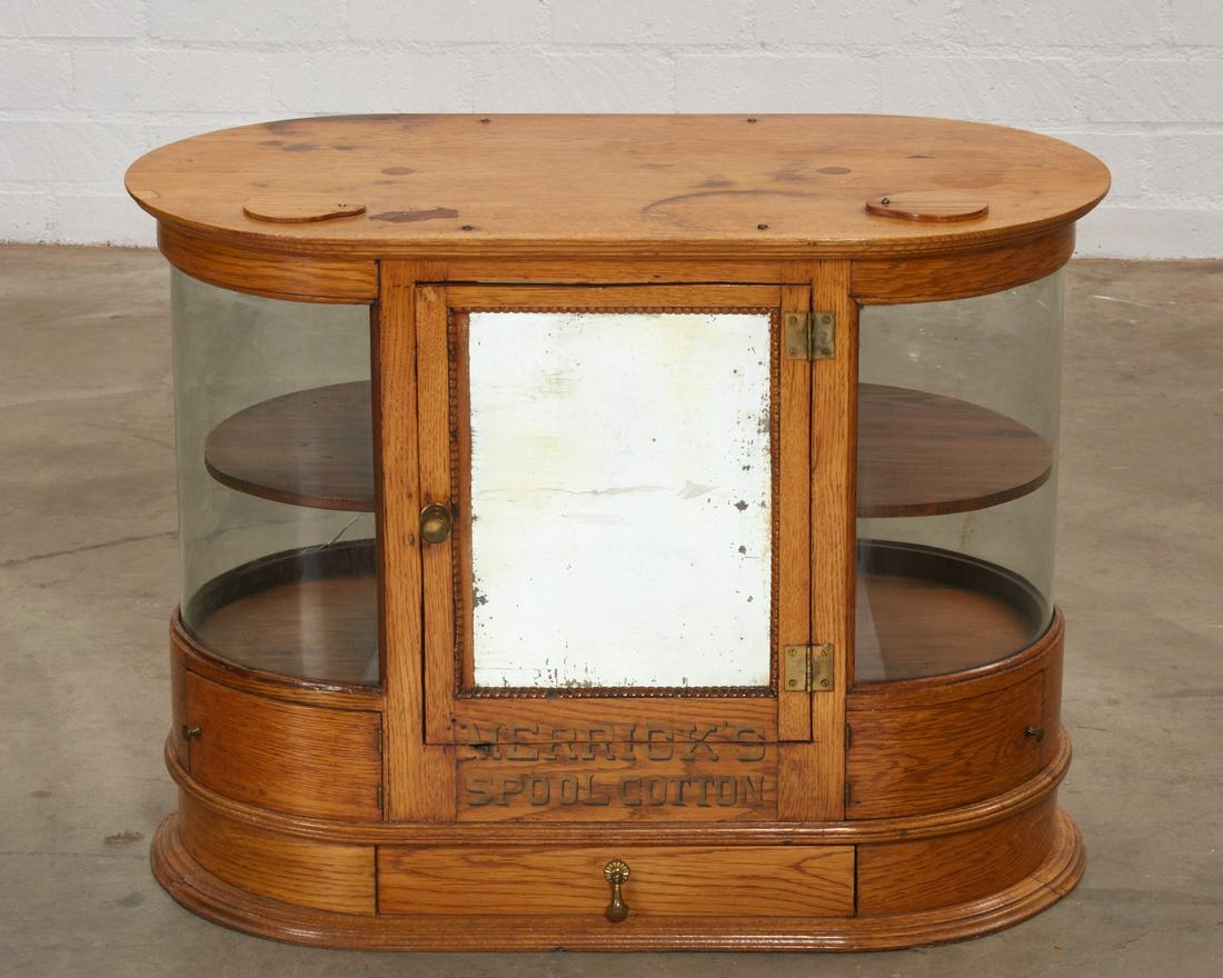 A Merrill golden oak spool cabinet: A Merrill golden oak spool cabinetearly 20th centuryheight 22 3/4in (57.5cm); width 31 1/2in (80cm); depth 17in (43cm)Condition: Crack to glazed panel as visible in catalogue photos. General marks, ni