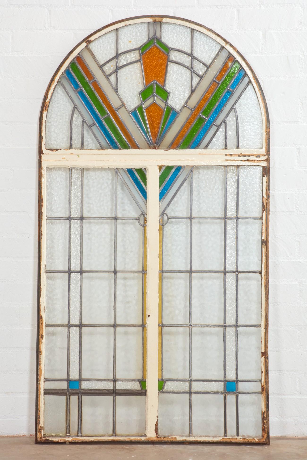 An Art Deco arched leaded glass window: An Art Deco arched leaded glass window first quarter 20th century height 71in (180.5cm); width 39 1/4in (99.7cm); depth 2 1/2in (6.5cm)