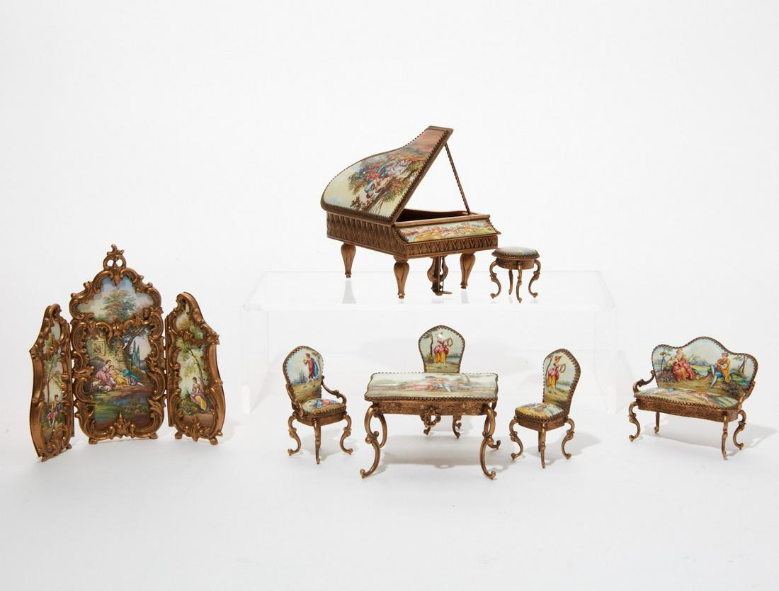 A suite of Austrian miniature furniture: A suite of Austrian gilt metal and enamel miniature furniture 20th century Comprising three fold floor screen, settee, armchair, pair of side chairs, circular occasional table, table and piano, most i
