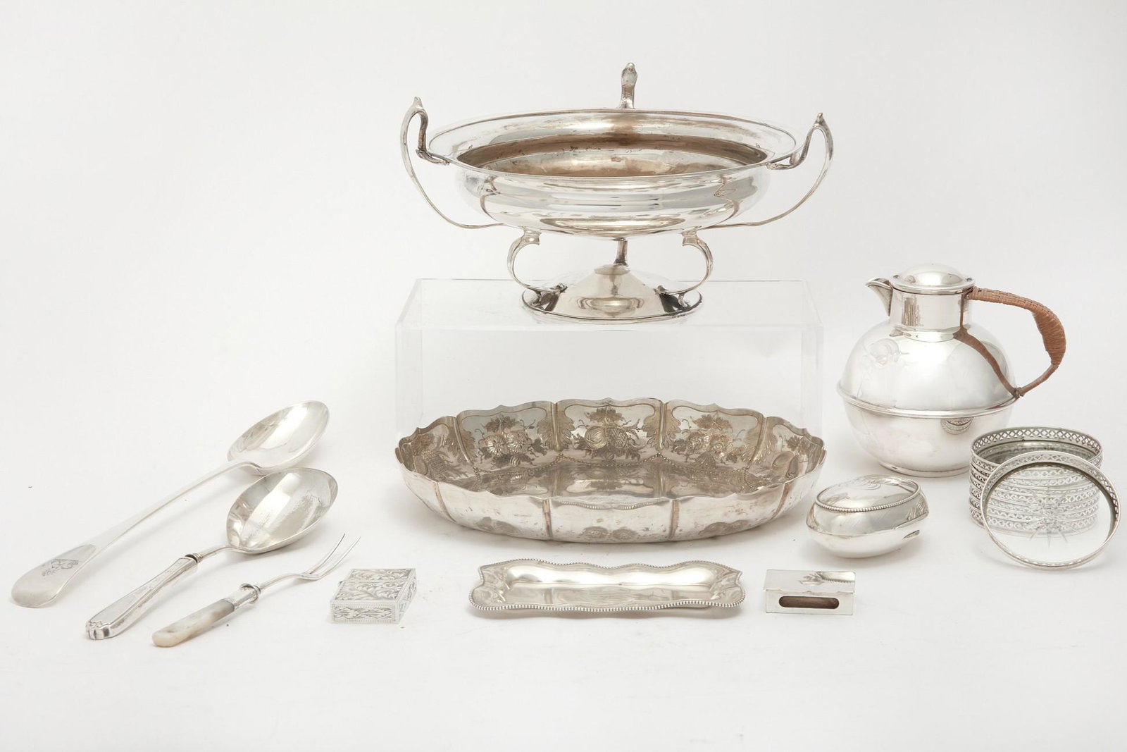 Eighteen silverplate and silver tablewares: An eighteen piece group of silverplate and silver tableware and accessories various makers late 19th-20th century Comprising a pedestal bowl, a hot water jug, an oval bowl, a serving spoon, a meat for