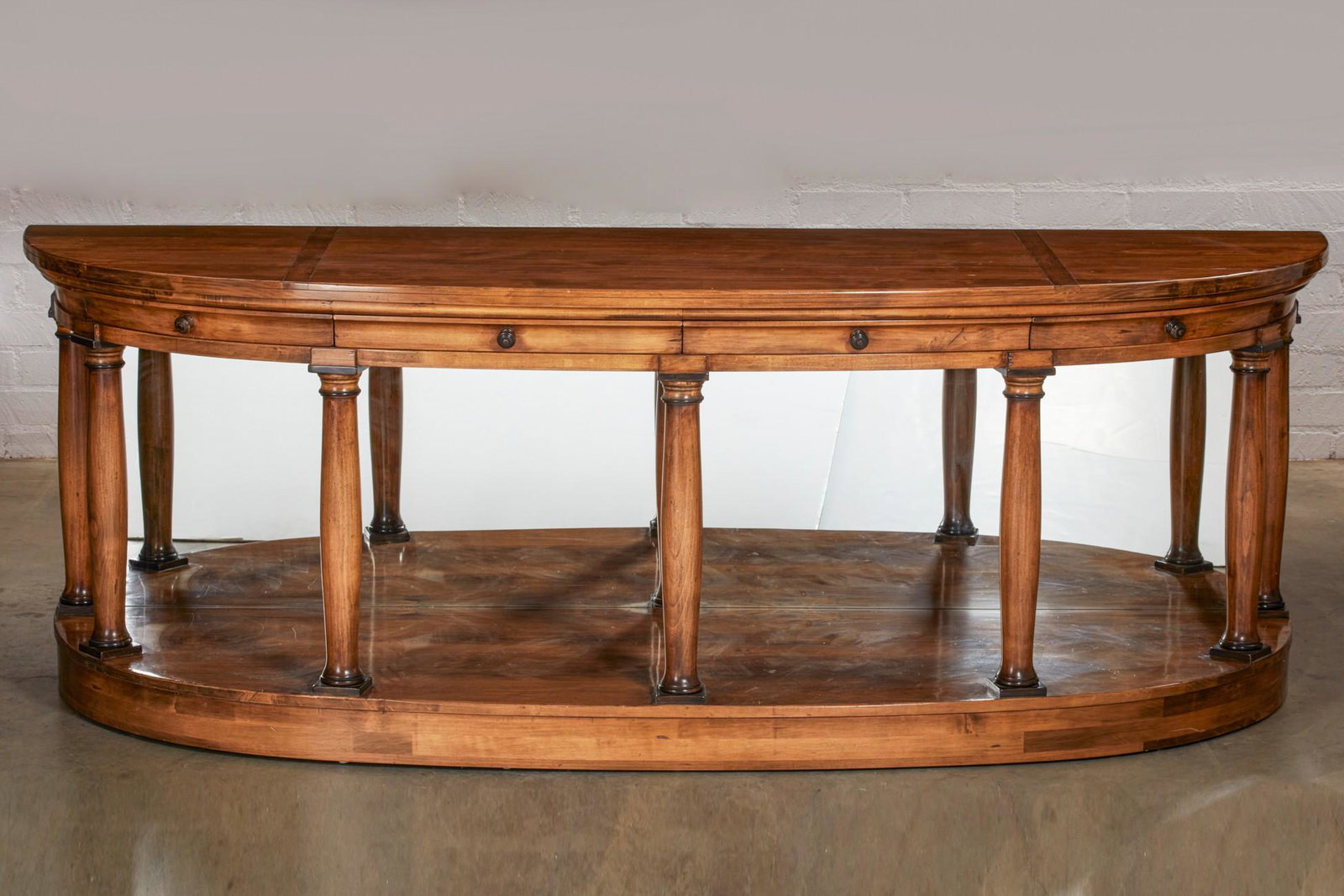 A Thomas Morgan Neoclassical style console table: A Thomas Morgan Neoclassical style walnut console table modern With four frieze drawers. height 39in (99cm); width 96in (244cm); depth 30in (76cm) Provenance: Property from a private collection, Pacif