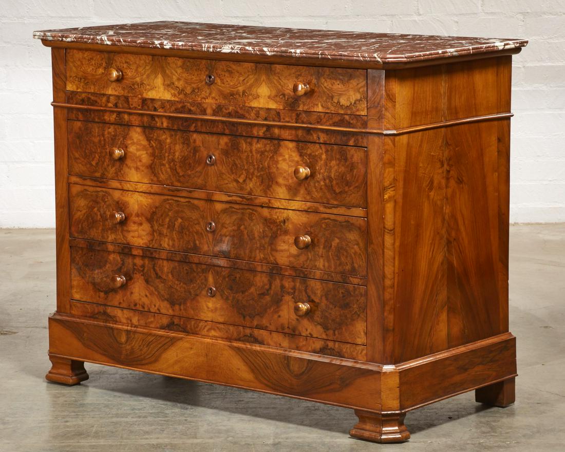 A Charles X burr walnut commode: A Charles X burr walnut commodesecond quarter 19th centuryWith rouge royal marble top.height 40in (102cm); width 51 1/2in (131cm); depth 24in (61cm)