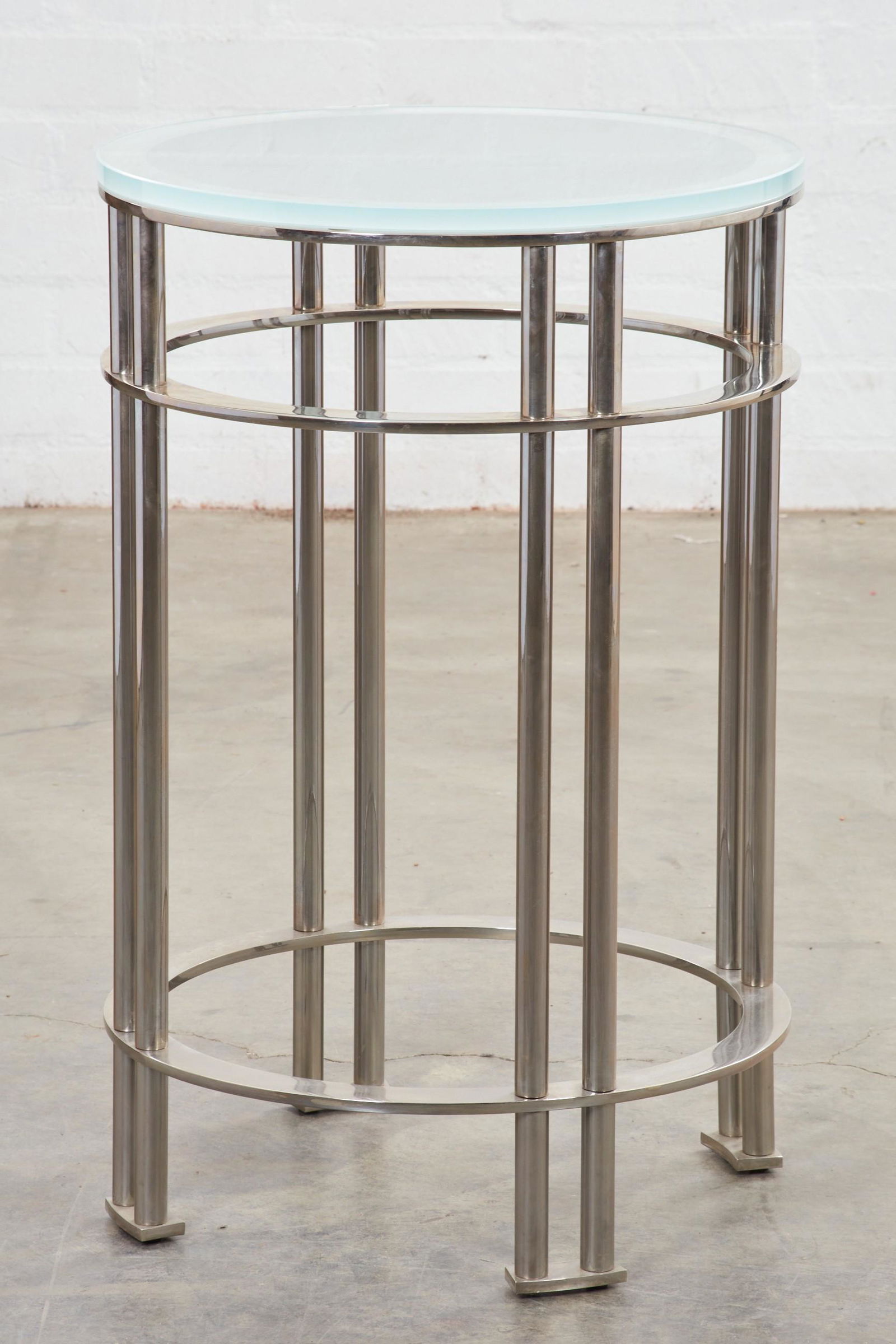 A Modernist chrome and glass circular table: A Modernist chrome and frosted glass circular occasional tablepost 1950height 32 1/2in (82cm); diameter 21in (53cm) Provenance:Property from a Craig Wright designed residence of a former Getty Trustee