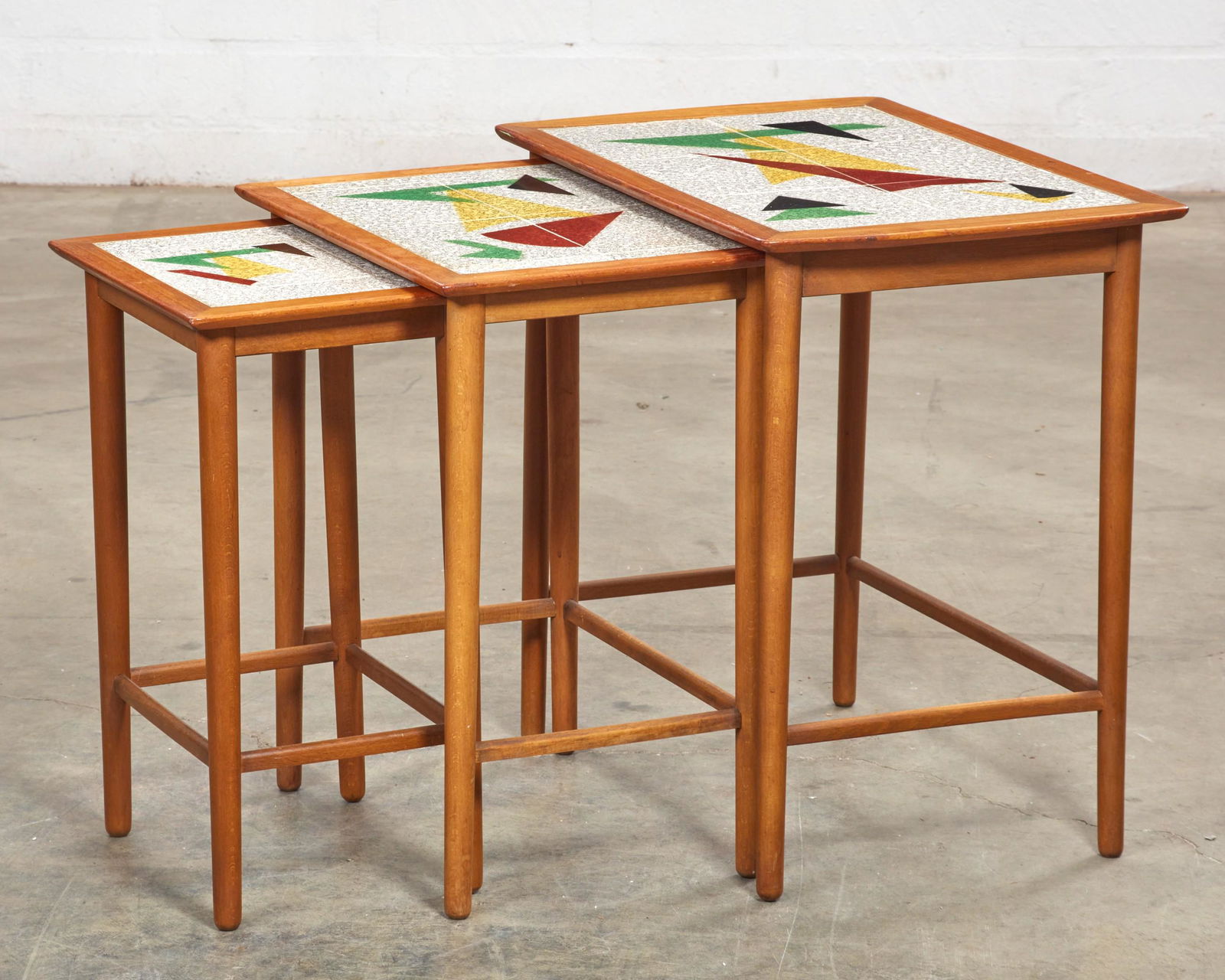 A nest of three Danish tile inset teak tables (1 of 3)