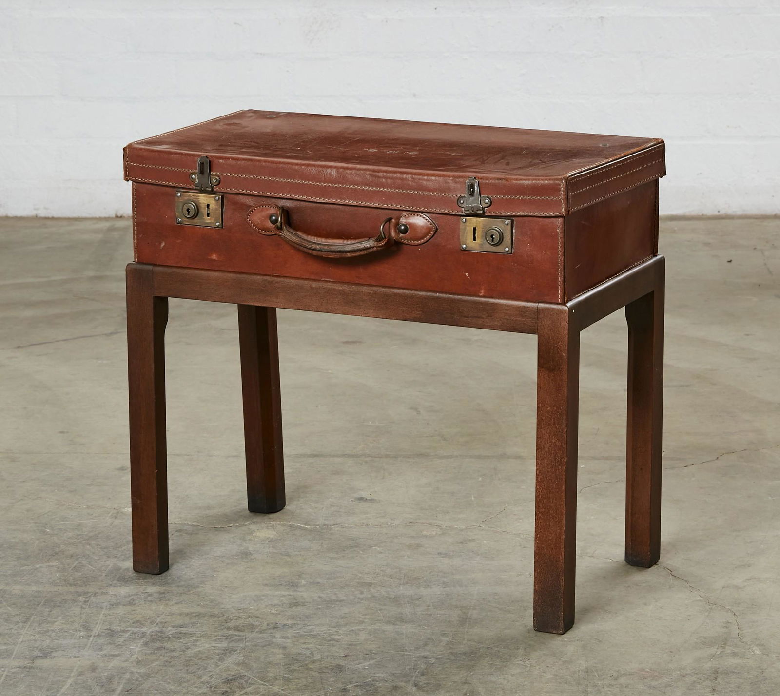 A vintage leather suitcase on stand (1 of 6)