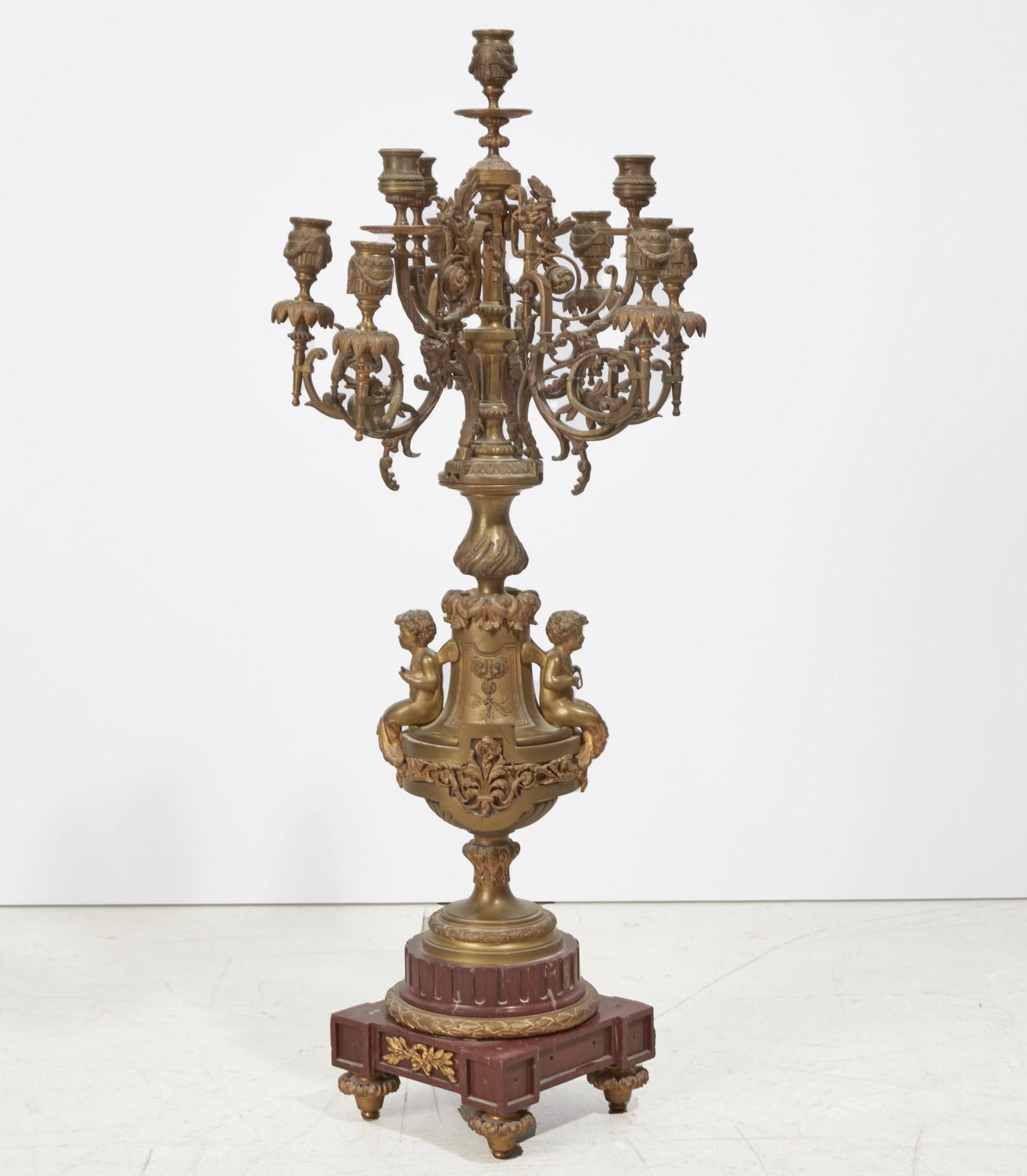 A Louis XVI style bronze marble candelabrum: A Louis XVI style bronze and rouge royal marble candelabrum late 19th century height 35in (89cm); diameter 14in (36cm)