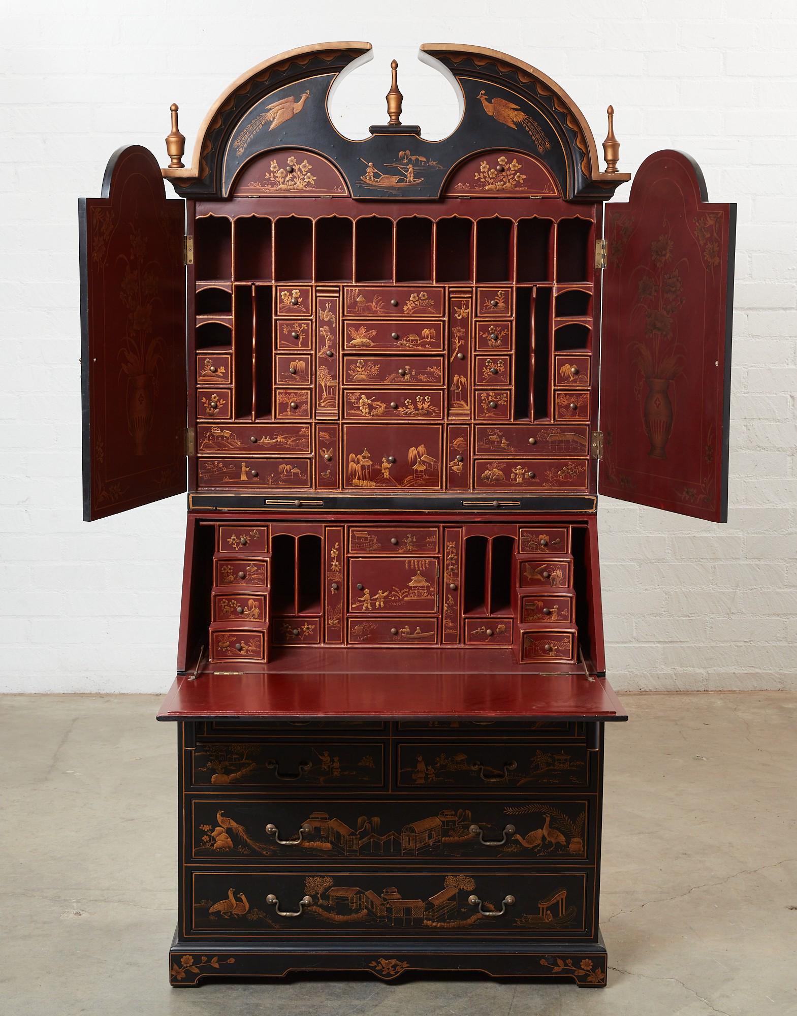 A George I style Chinoiserie secretary cabinet: A George I style black and gold painted Chinoiserie decorated secretary cabinet modern The upper section with a pair of doors enclosing an arrangement of drawers, pigeonholes and document slots over a