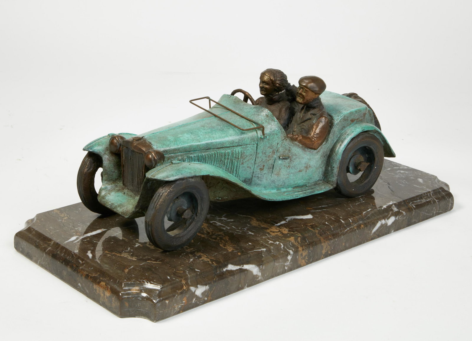 A bronze sculpture of a couple driving (1 of 3)
