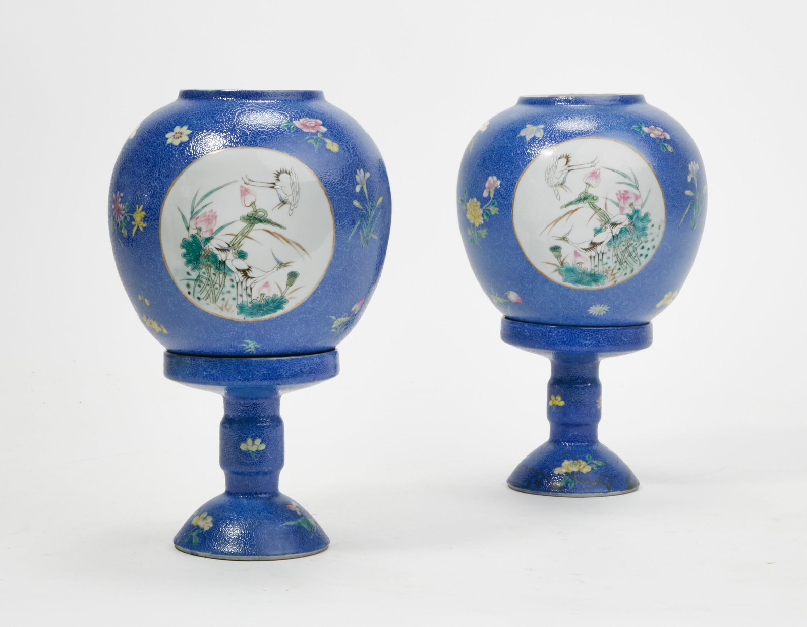 A pair of Chinese Famille Rose porcelain lanterns: A pair of Chinese blue ground Famille Rose porcelain lanterns overall height 11 3/4in (30cm); diameter 6 1/2in