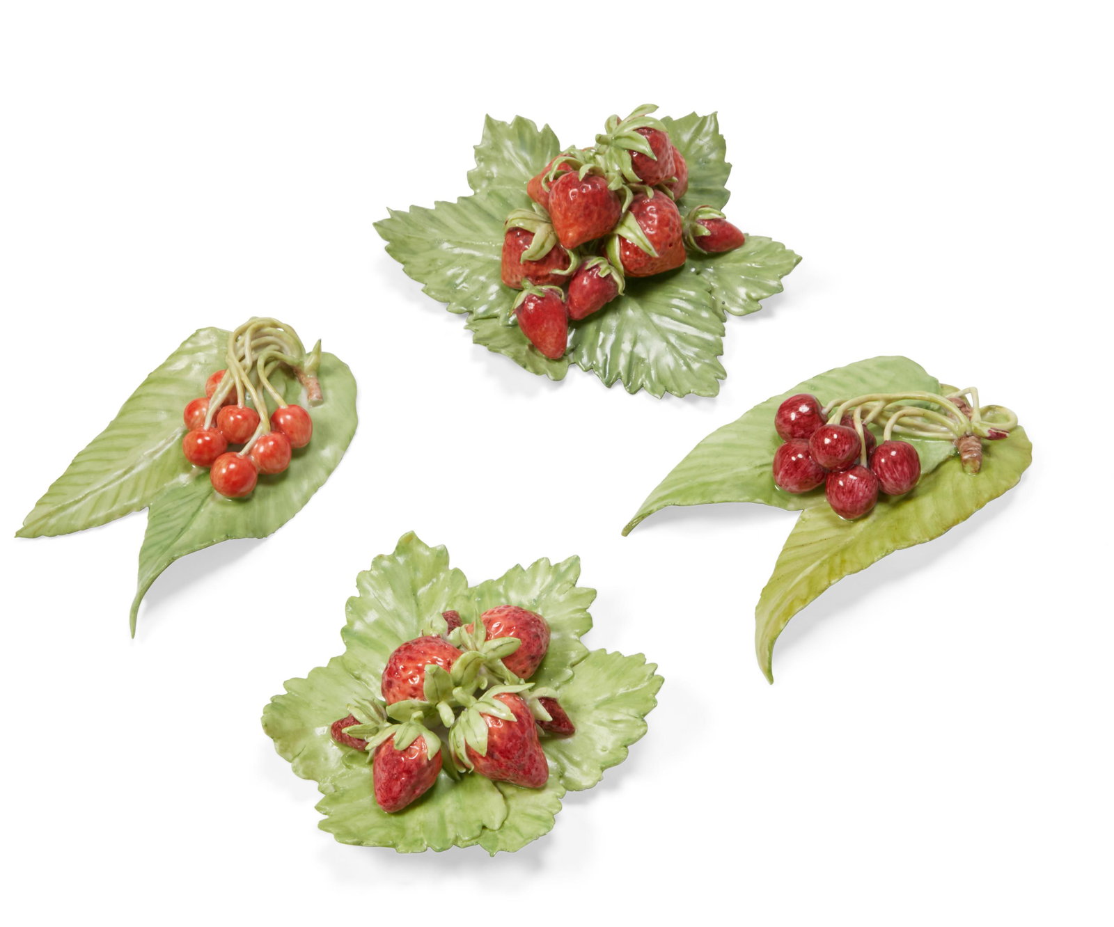 Four porcelain models of berries, Anne Gordon: A group of four porcelain models of strawberries and cherries on leaves Anne Gordon (Scottish, b.1941) circa 1985 Each with artists monogram and three dated 85. heights ranging from 1 to 2 1/4in (2.5 