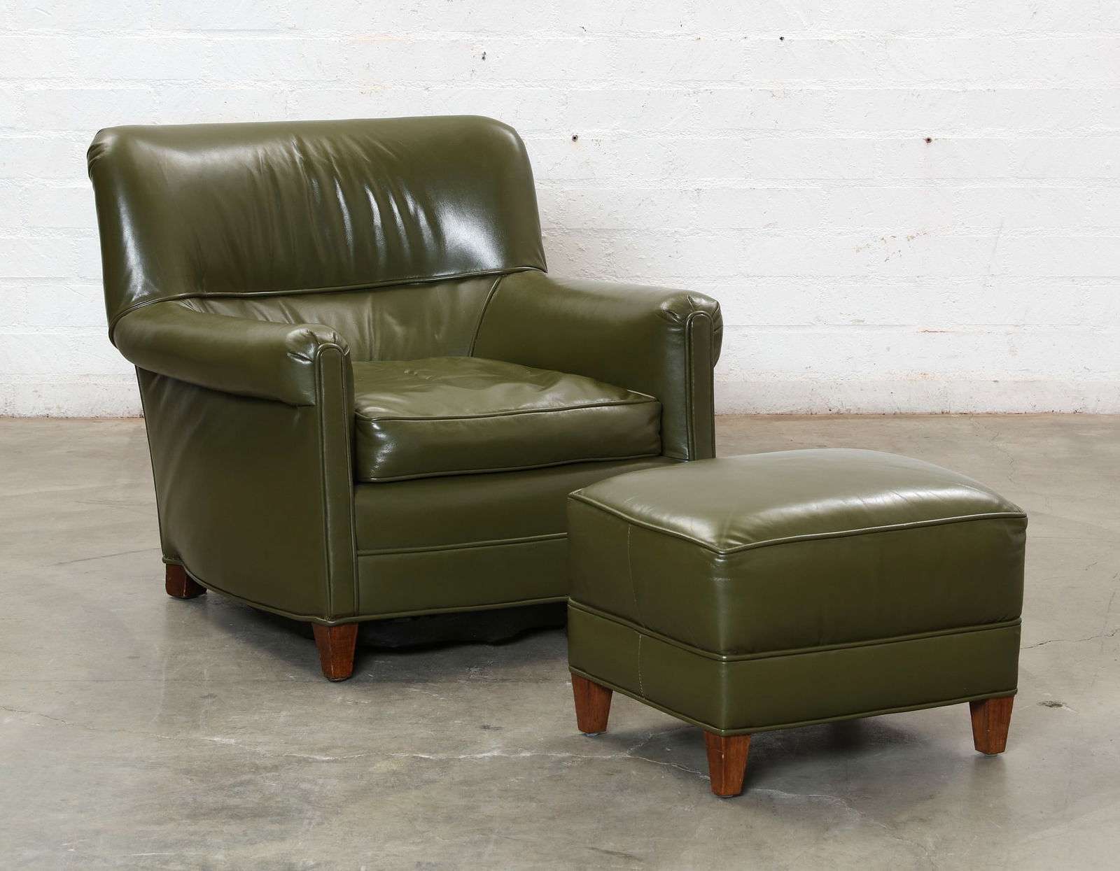 A Green Leather Upholstered Club Chair Ottoman