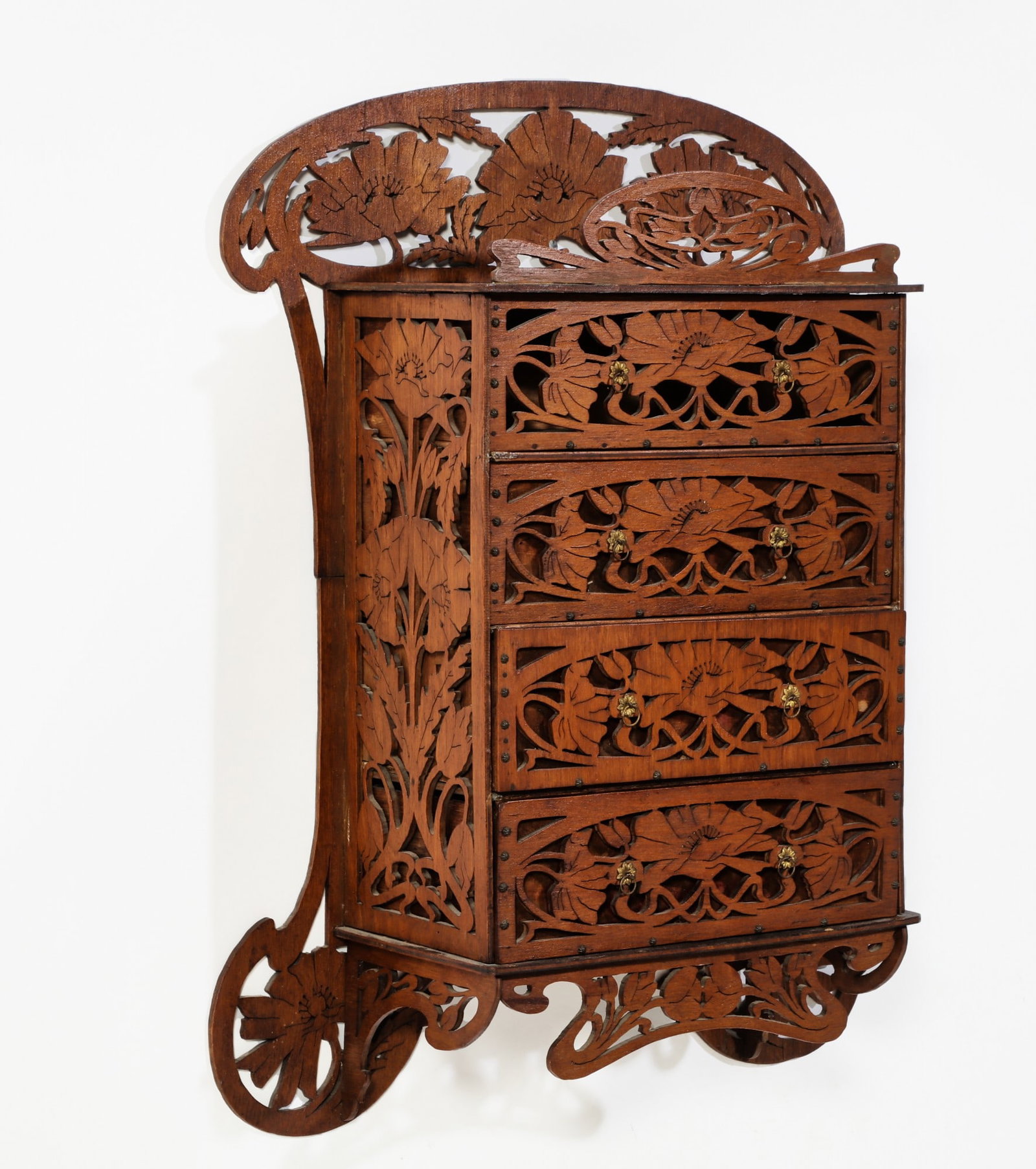An Art Nouveau walnut fretwork mural chest: An Art Nouveau walnut fretwork mural chest early 20th century height 25 1/2in (65cm); width 19in (48.5cm); depth 6 1/2in (16.5cm) Provenance: Property from the estate of Bobby Sang Diamond, Hancock Pa