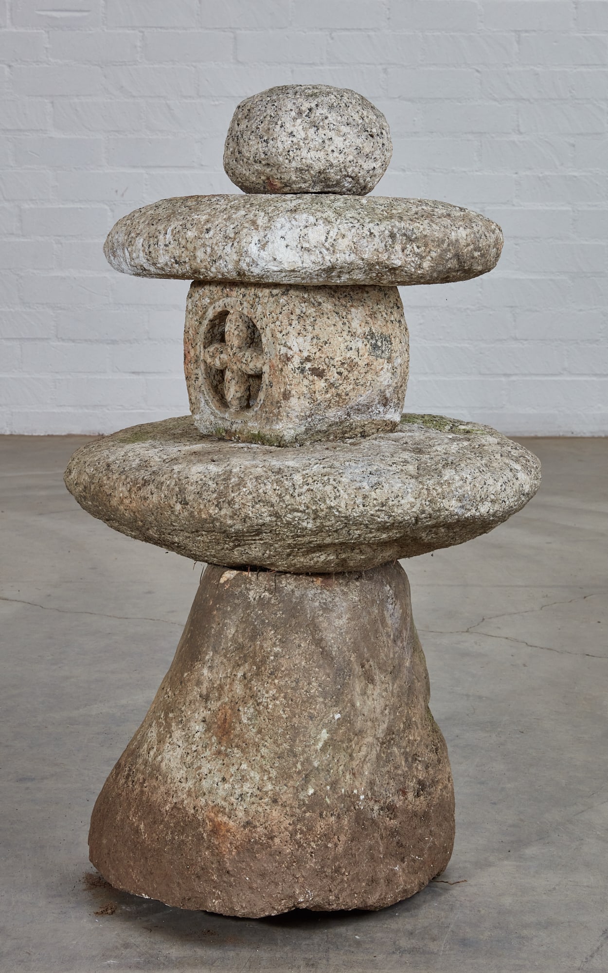 A Japanese stone lantern: A Japanese stone lantern height 39in (99cm); width 24in (61cm); depth 18in (46cm)