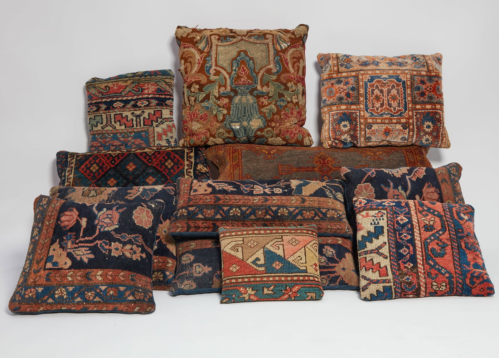 Twelve carpet and tapestry fragment cushions (1 of 5)