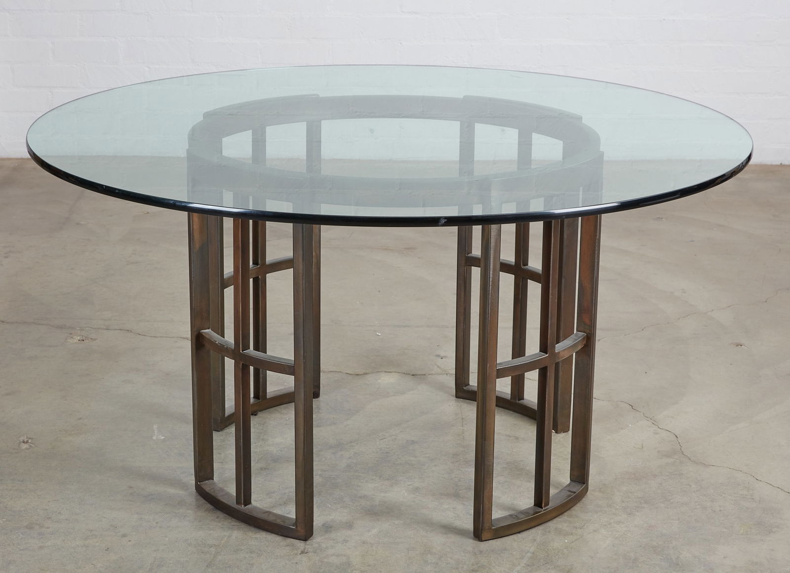 A Modernist metal and glass circular dining table (1 of 3)