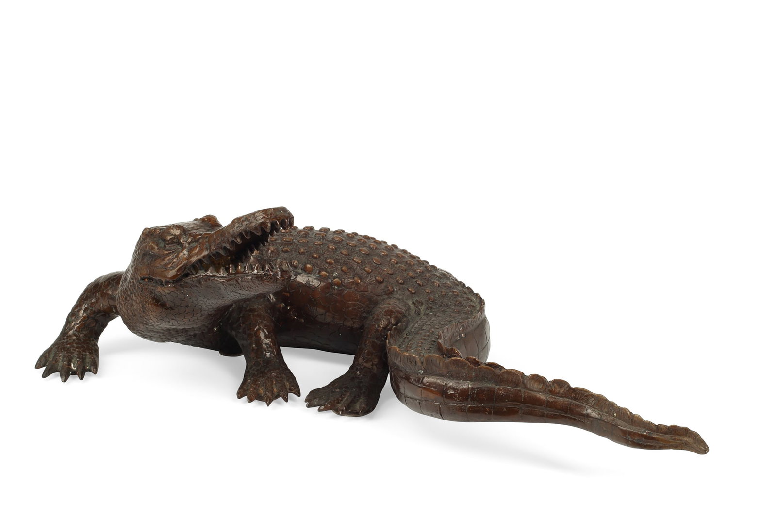 A bronze model of a crocodile: A patinated bronze model of a crocodile modern height 7 1/4in (18.5cm); length 23 1/2in (59.5cm); depth 13 1/4in (33.5cm)