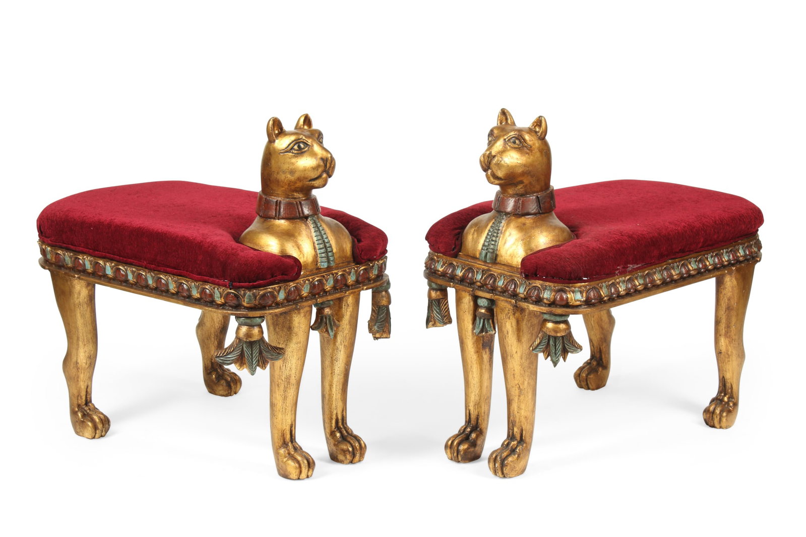 A pair of Egyptian stylegiltwood stools: A pair of Egyptian style parcel paint decorated and carved giltwood stools post 1950 height 29in (74cm); width 29in (74cm); depth 20in (51cm)