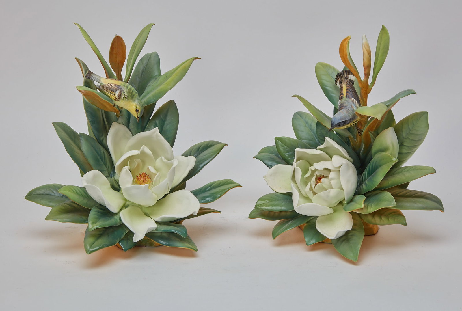 A pair of Royal Worcester porcelain birds: A pair of Royal Worcester porcelain models of birds: Magnolia Warblers and Magnolia modeled by Dorothy Doughty designed 1947; issued 1950 Shape numbers 3429 & 3430, black printed factory marks, titles