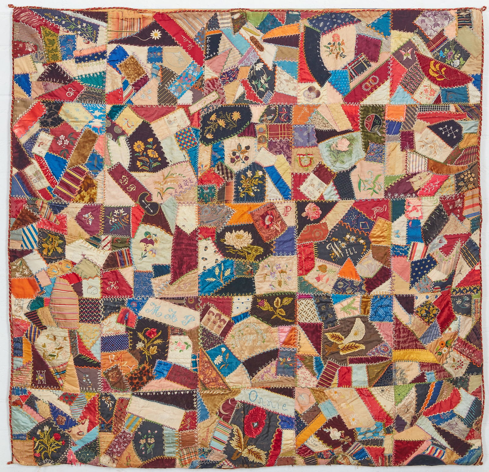 An American satin and silk pieced crazy quilt: An American satin and silk pieced crazy quiltdated 1884Mounted on a lucite frame.55 x 57in (140 x 145cm) Provenance:The Edmund W. and Carol Browning Dumke Family Trust.Footnote: