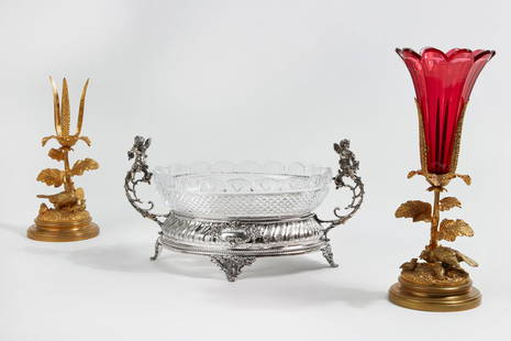 A group of Continental metalware tableware: A three piece group of Continental metalware decorative tableware late 19th-20th century Comprising a pair of gilt bronze vase frames, one with cranberry glass insert and a Neoclassical style