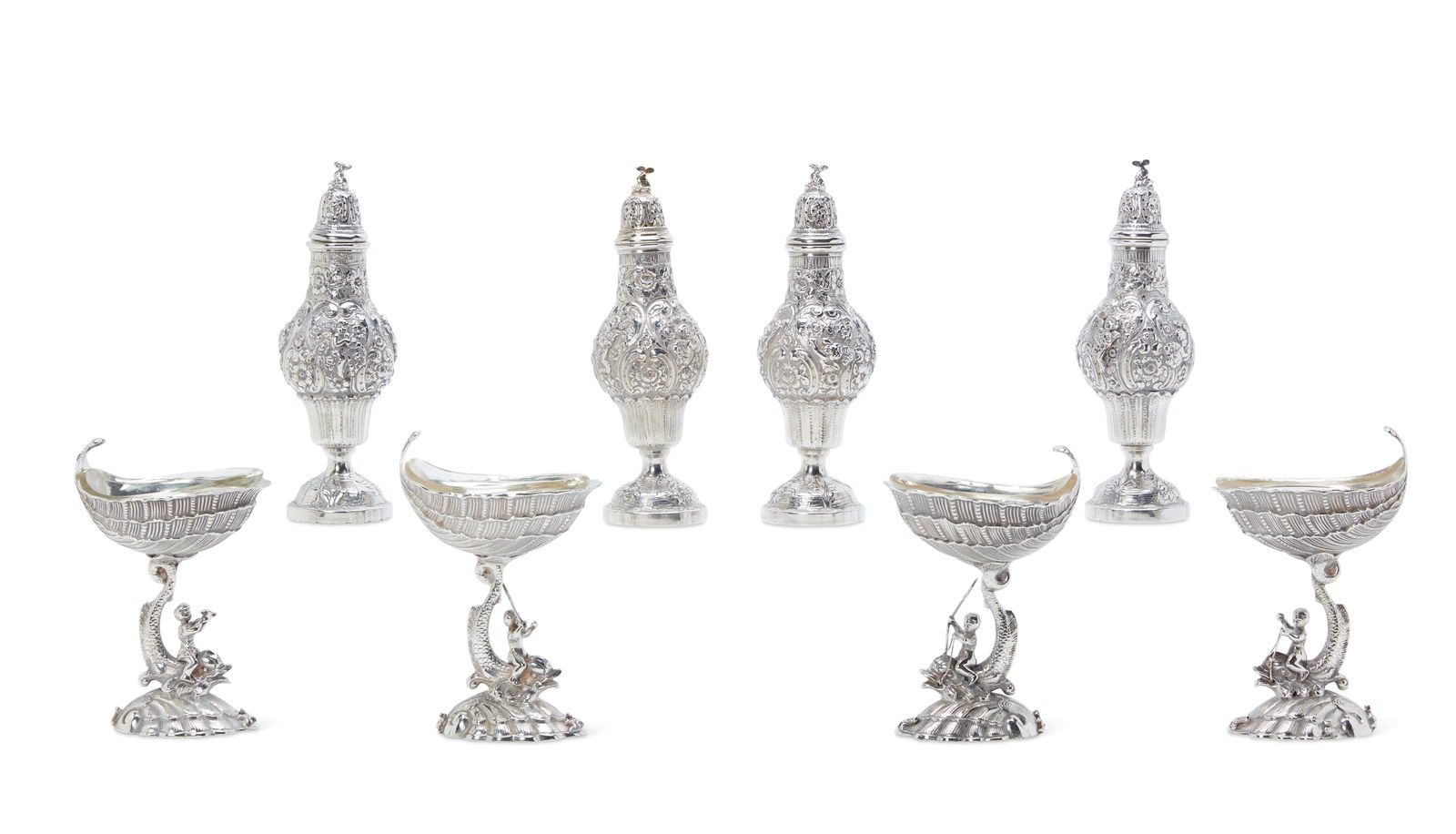 An eight piece German silver condiment se: An assembled eight piece German silver condiment setprobably Hanauearly 20th centuryour pedestal salt cellars (one possibly later cast) with glass liners and four casters.the casters height 8in (20cm)