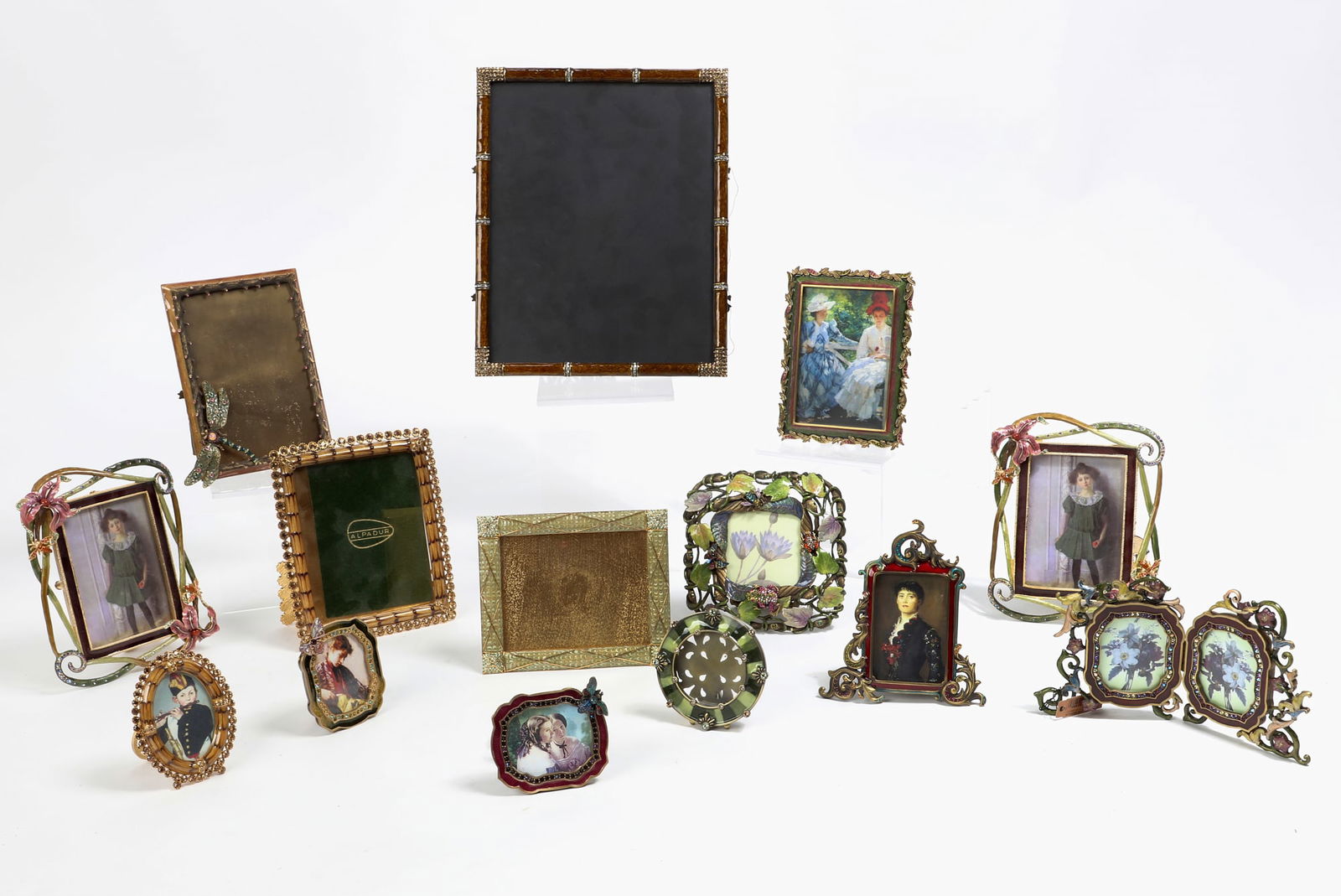 Fourteen Jay Strongwater metalware picture frames: A collection of fourteen Jay Strongwater enameled and 'jeweled' metalware table top picture framesmodernlargest 10 3/4 x 8 3/4in (27 x 22cm) Provenance:The Edmund W. and Carol Browning Dumke Family Tr