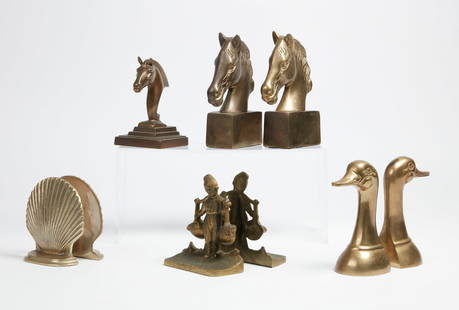 Four pairs of brass bookends: Four pairs of brass bookendsComprising pairs modeled as duck heads, horse heads, scallop shells, and Dutch boys together with a single bookend modeled as a horse head. (9)height of largest 7 1/4in (18