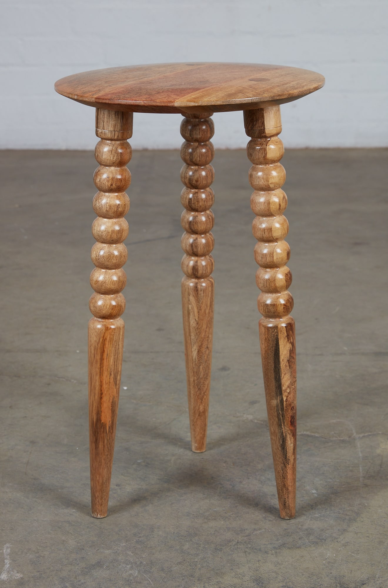 A Butler Specialty Company wood Fluornoy table: A Butler Specialty Company mango wood Fluornoy side table modern With maker's label to underside. height 23 1/4in (59cm); diameter 14in (35.5cm)