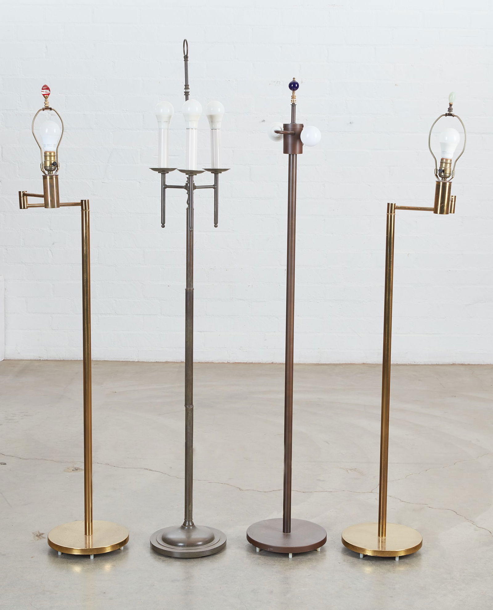A group of four mixed metal floor lamps (1 of 8)