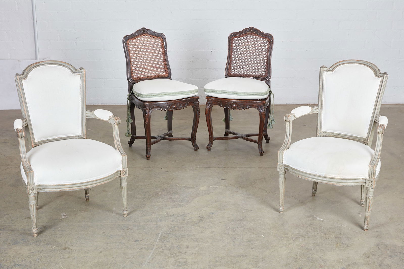 A pair of Louis XV fauteuils with caned chaises: A pair of Louis XV grey painted fauteuils and a pair of Regence style caned chaises(4)height of fauteuils 34 1/2in (87.5cm); width 23in (58.5cm); depth of seat 18 1/2in (47cm)