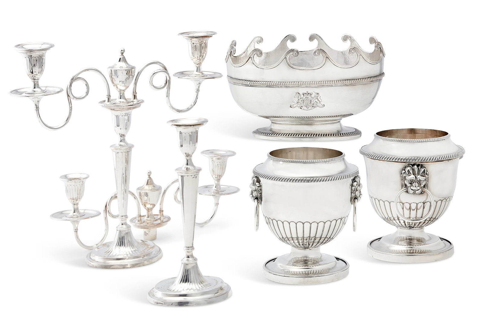 A five piece group of Old Sheffield tableware: A five piece group of Old Sheffield plate tableware 19th century Comprising a pair of wine bottle coolers, a monteith bowl with Royal Coat of Arms and a pair of convertible three light candelabra. can