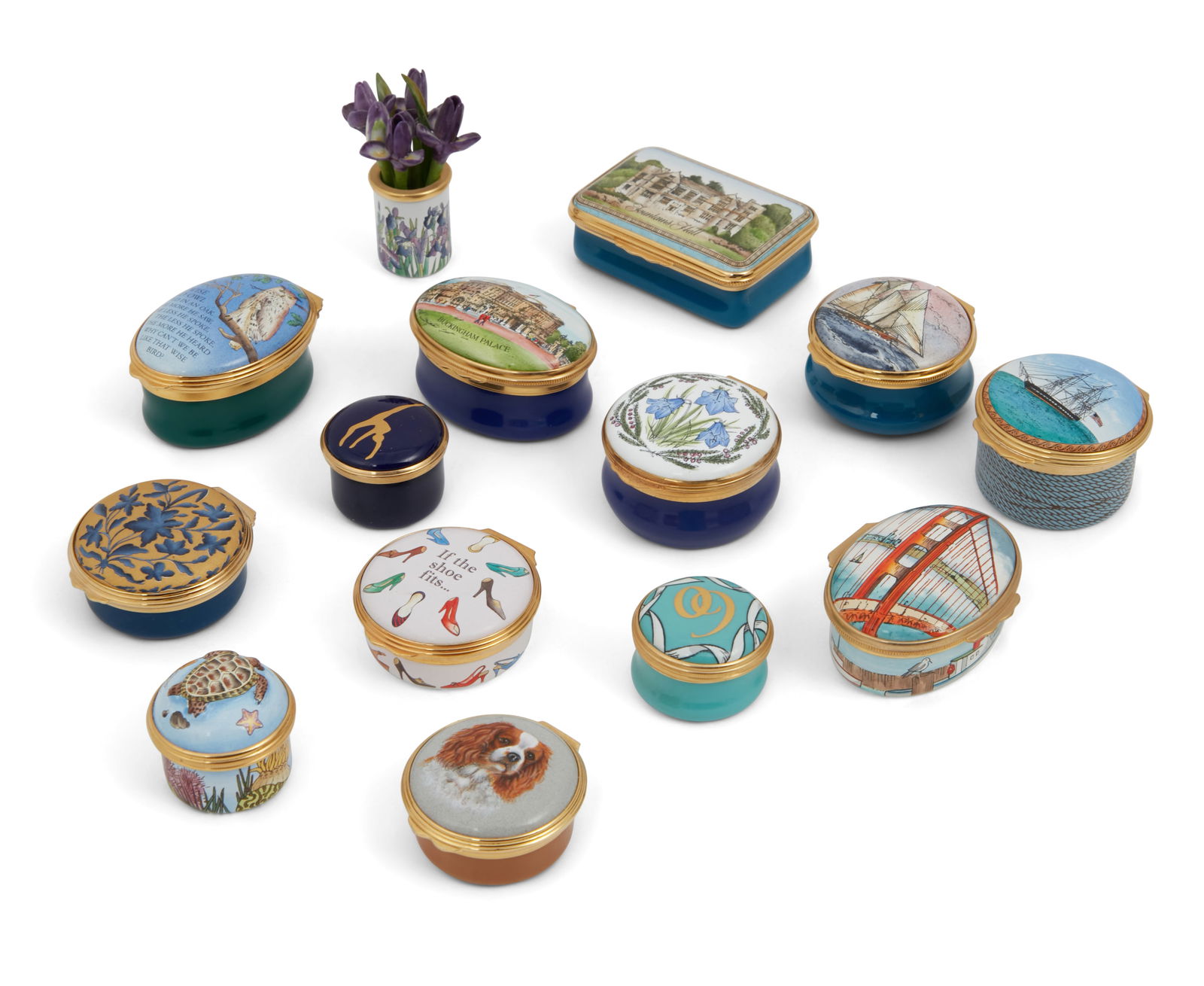 Fourteen Staffordshire enamel articles: A group of fourteen Staffordshire gilt metal mounted enamel articles20th centuryComprising twelve pill boxes by Halcyon Days, one miniature vase of irises by Halcyon Days and one pill by Crummles, som