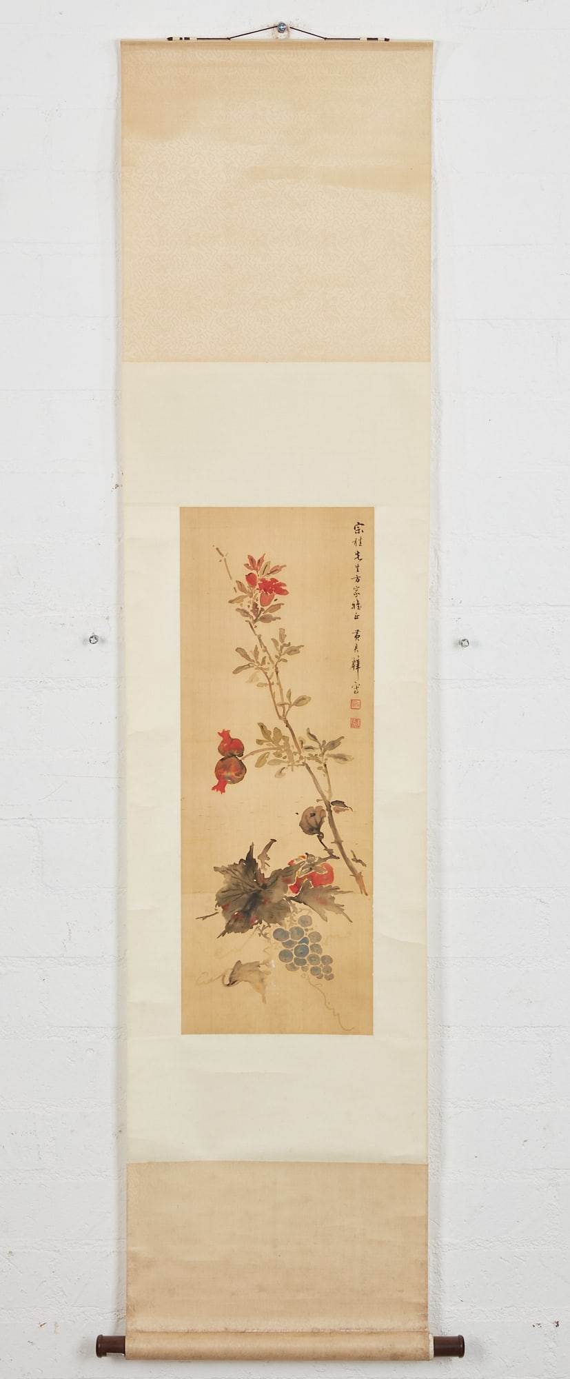A Chinese floral and fruit hanging scroll: A Chinese floral and fruit hanging scroll In the manner of Huang Junbi. 28 1/2 x 10 1/2in (72 x 26.5cm) Provenance: Property of a Private Collector, Orange County, CA.