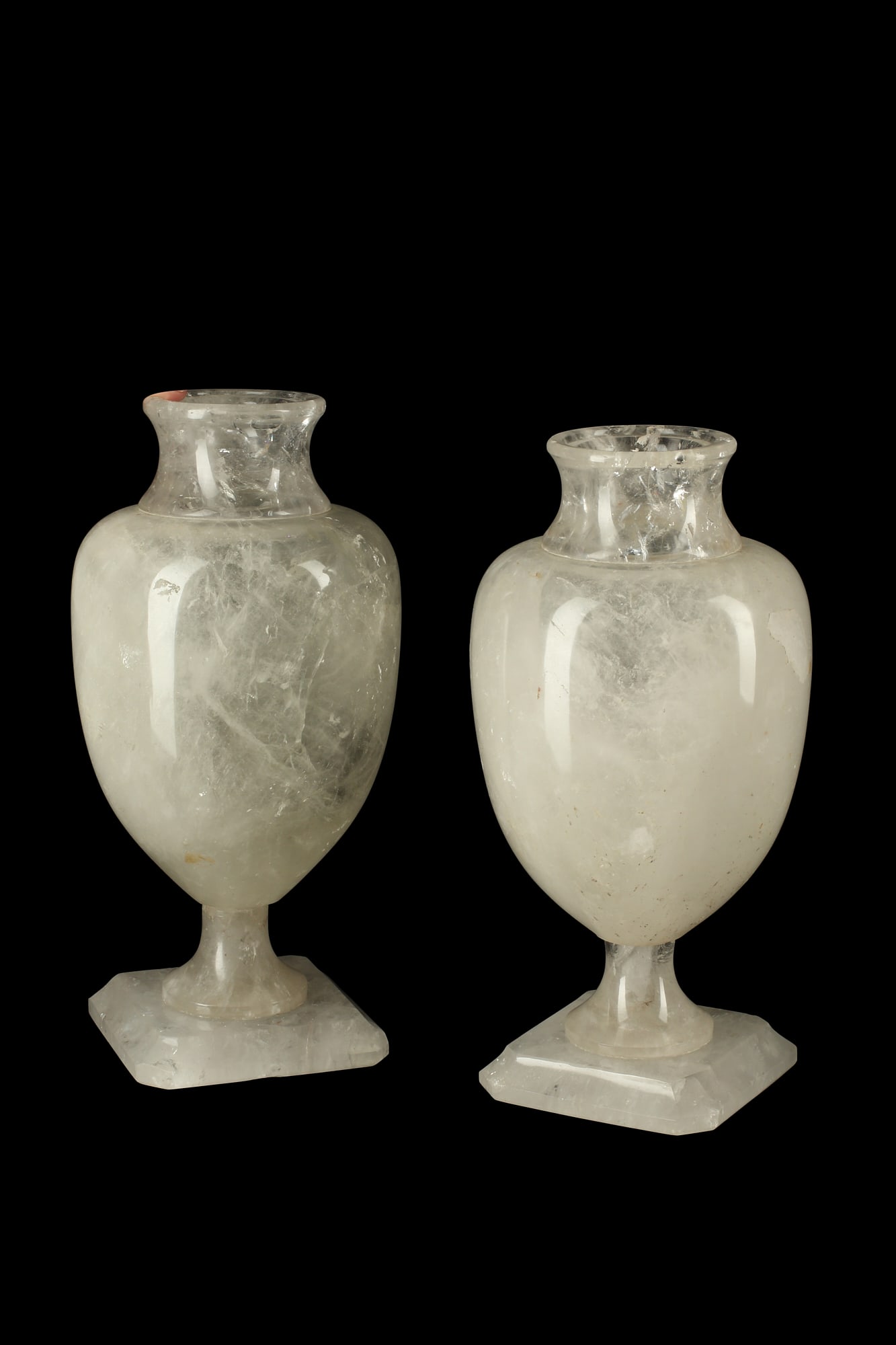 A pair of Neoclassical style rock crystal urns: A pair of Neoclassical style rock crystal urns height 14in (36cm); diameter 7in (18cm)