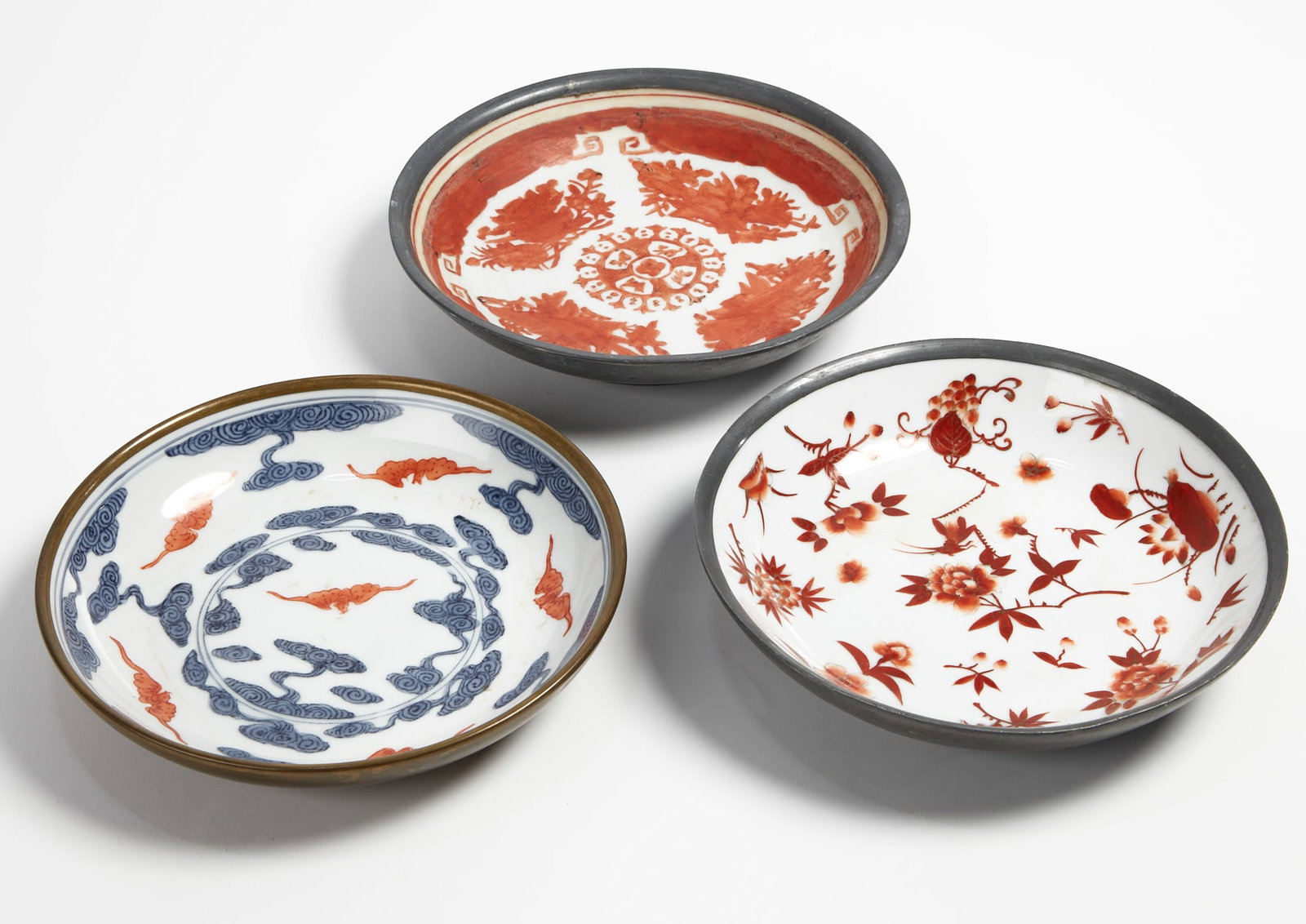 Three Japanese porcelain dishes: Three Japanese porcelain dishes With metal rims. diameter 8 in (20cm)