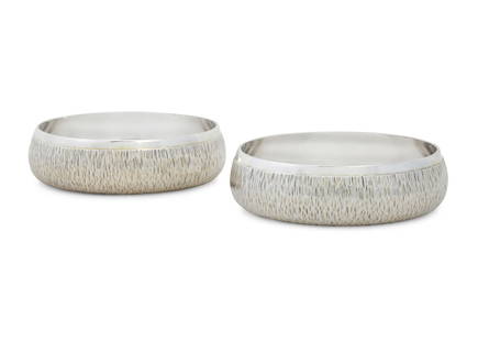 A pair of Elizabeth II sterling silver bowls: A pair of Elizabeth II sterling silver bowlsGerald Benney, London1974height 1 1/4in (3cm); diameter 4in (10cm); total weight approximately 10.5oz troy