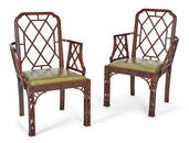 A pair of George III style mahogany cockpen armchairs