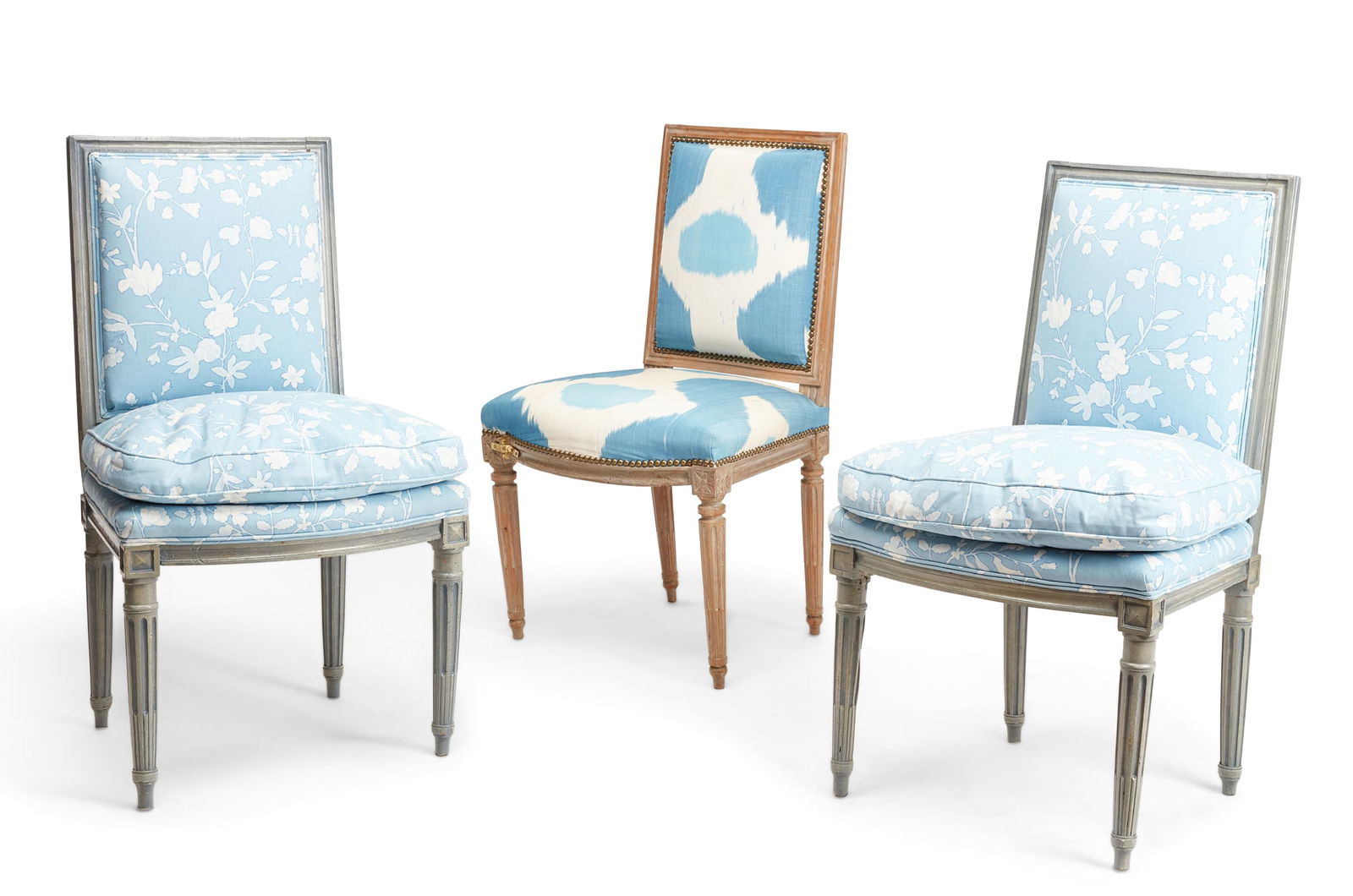 A pair of Louis XVI grey painted chaises: A pair of Louis XVI grey painted chaiseslate 18th centuryTogether with another. (3)the pair height 34in (87cm): width 19 1/2in (49.5cm); depth of seat 16in (41cm)