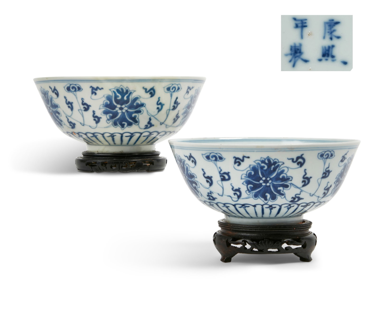 A pair of Chinese blue and white porcelain bowls: A pair of Chinese blue and white porcelain bowls One with four character mark to underside, on stands. height 3in (7.5cm); diameter 7 1/8in (18cm)