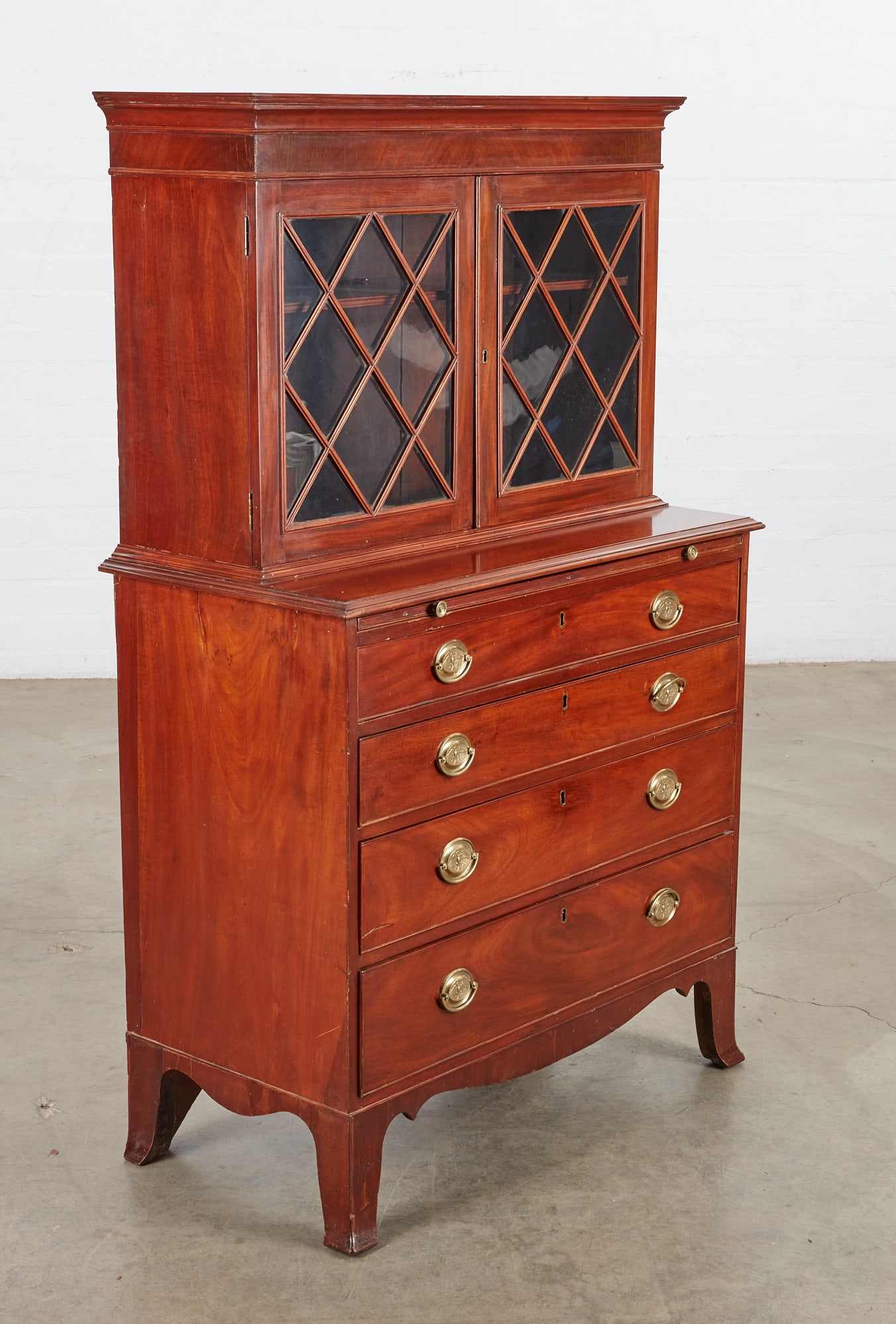 A Federal mahogany gentleman's dressing cabinet: A fine Federal mahogany glazed door gentleman's dressing cabinet New England, possibly New Hampshire circa 1800 In two sections. height 61 1/2in (156cm); width 37 1/2in (95cm); depth 19 1/2in (49.5cm)