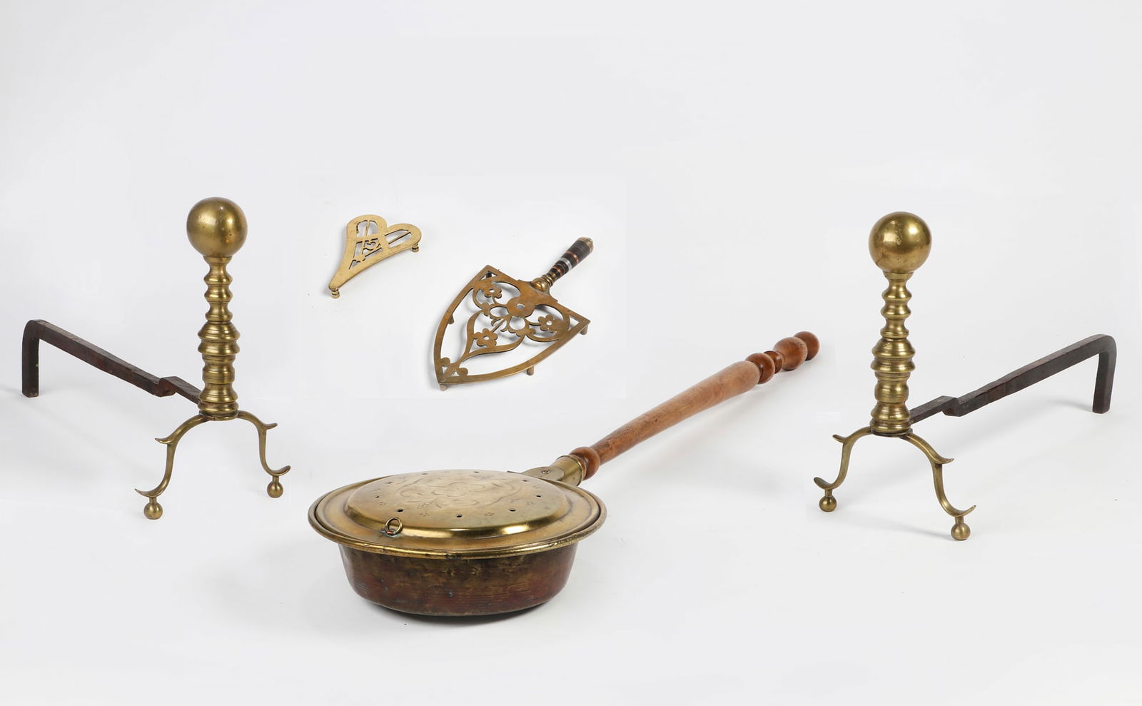 An American bed warmer with andirons and trivets: An American brass and maple handled bed warmer19th centurytogether with a pair of brass andirons and two brass trivets, the smaller with hand etched FLORENE MAINE / XMAS 1977 to underside. (5)andirons