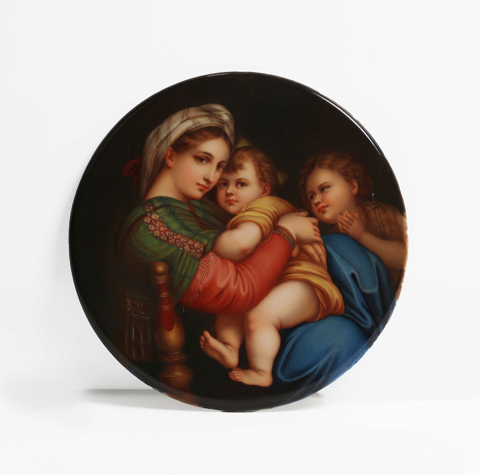 A Continental porcelain plaque: A Continental porcelain plaque: Madonna della Sedia20th centuryAfter the painting by Raphael, pseudo impressed K.P.M. mark.diameter 7 3/4in (19.5cm)
