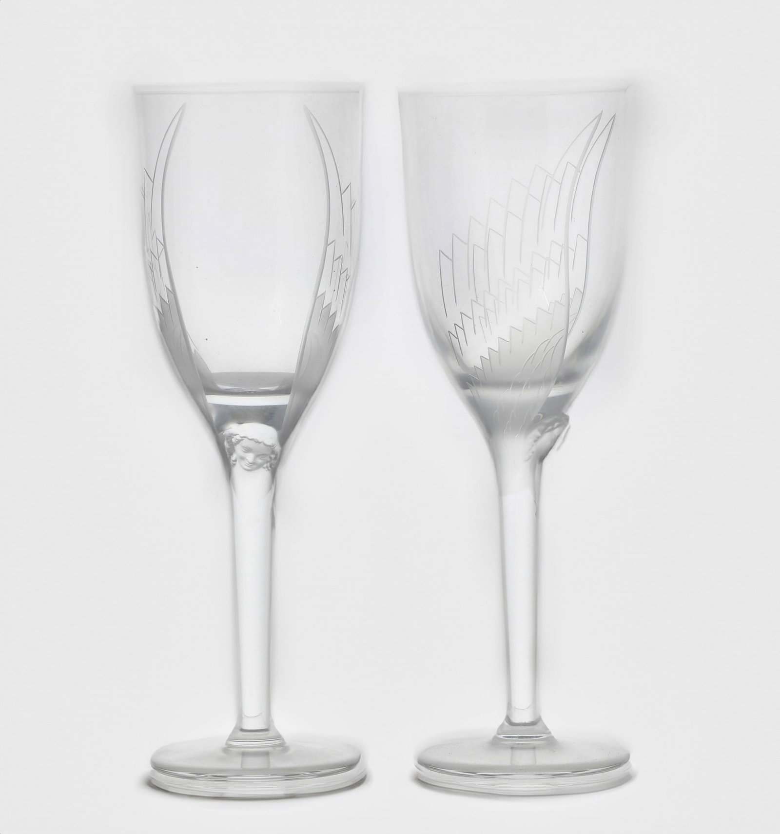 Fifteen Lalique glass champagne flutes: A suite of fifteen Lalique clear and frosted glass champagne flutes in the Ange pattern modern Etched Lalique® France. height 8in (20.3cm)